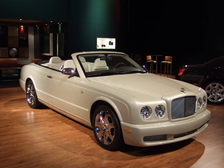white convertible convertible parked on wooden floor in large room