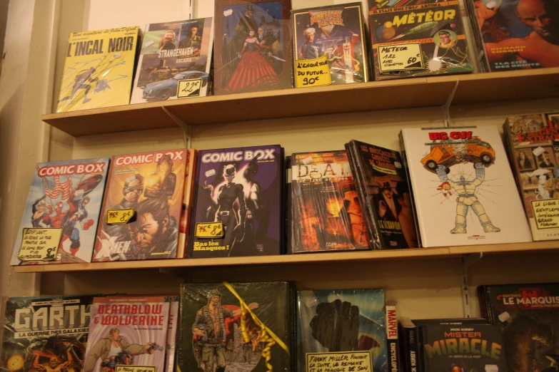 various comics are on shelves in a comic book store