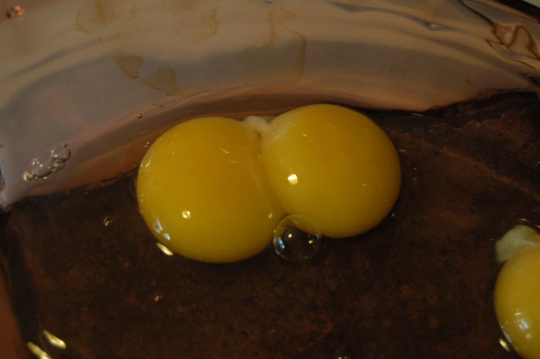 three hard boiled eggs are in a silver container