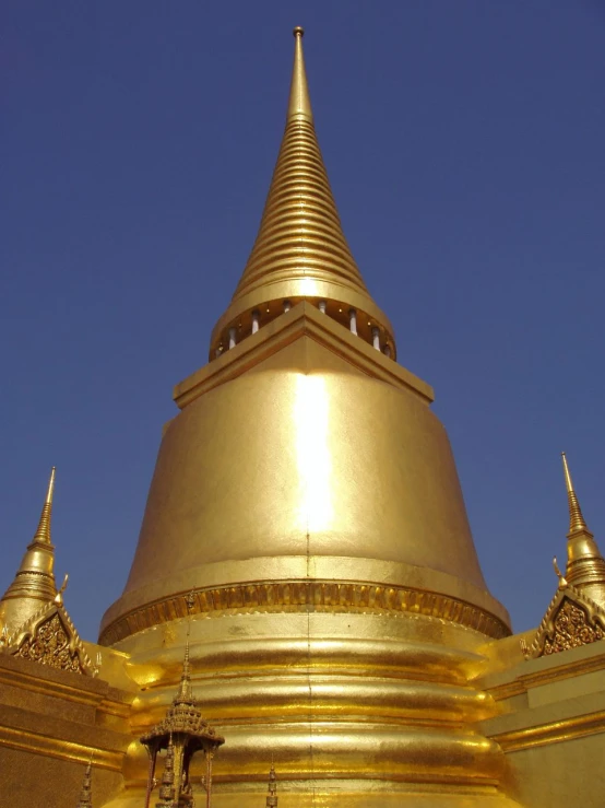 a large gold colored structure with golden carvings on it