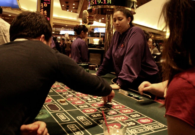 some people sit and play casino machines at the table