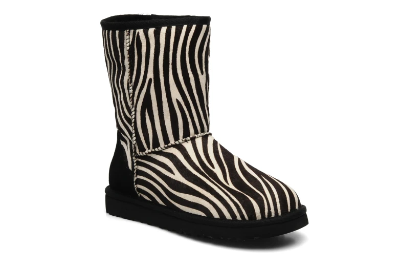 a pair of ze print boots on white background