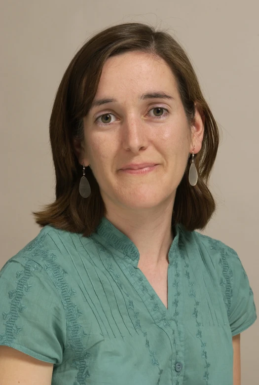 a woman standing and smiling in a pose