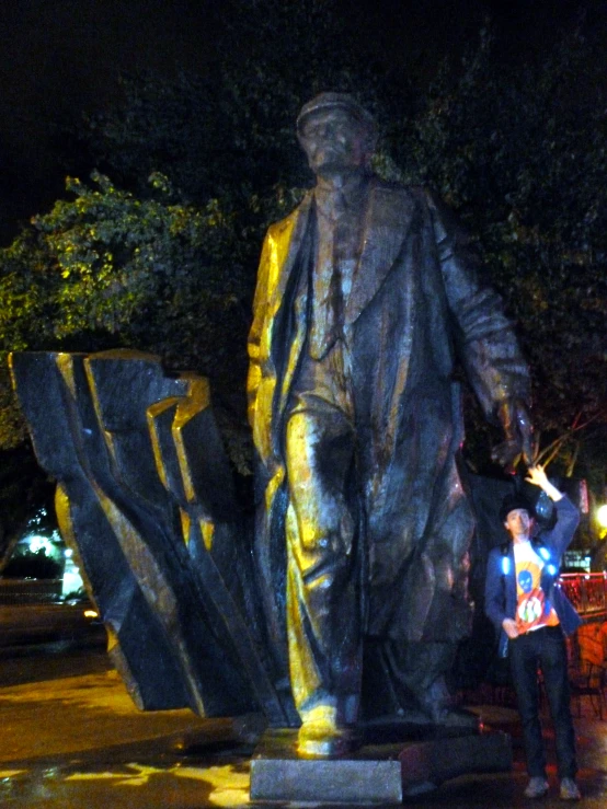 a person taking a po near a statue