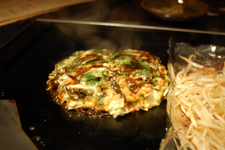 an omelette cooking with pasta on the side