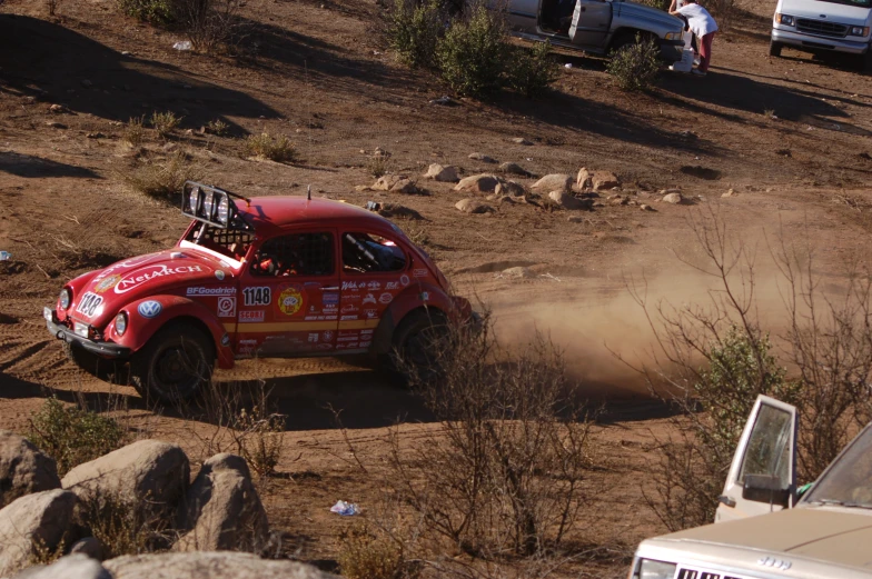 an old dirt truck making a turn on a race track