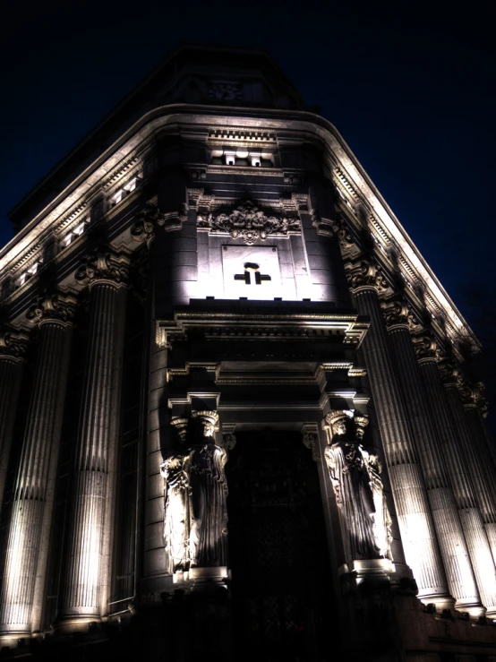 an ornate building with lit up crosses at night