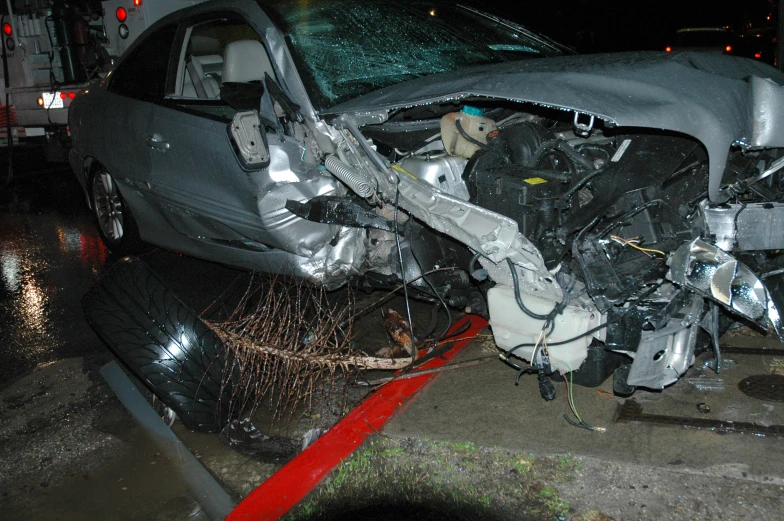 a car that has it's hood partially ripped off is shown from the side