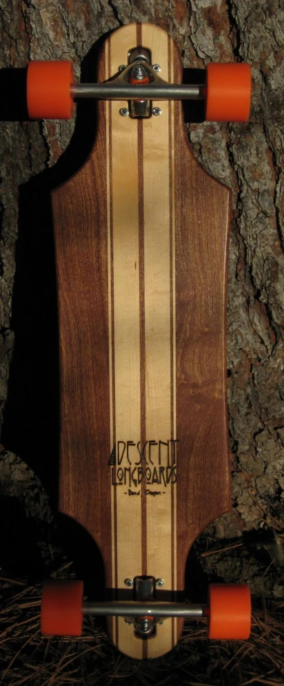 a long board sits by a tree in the dark