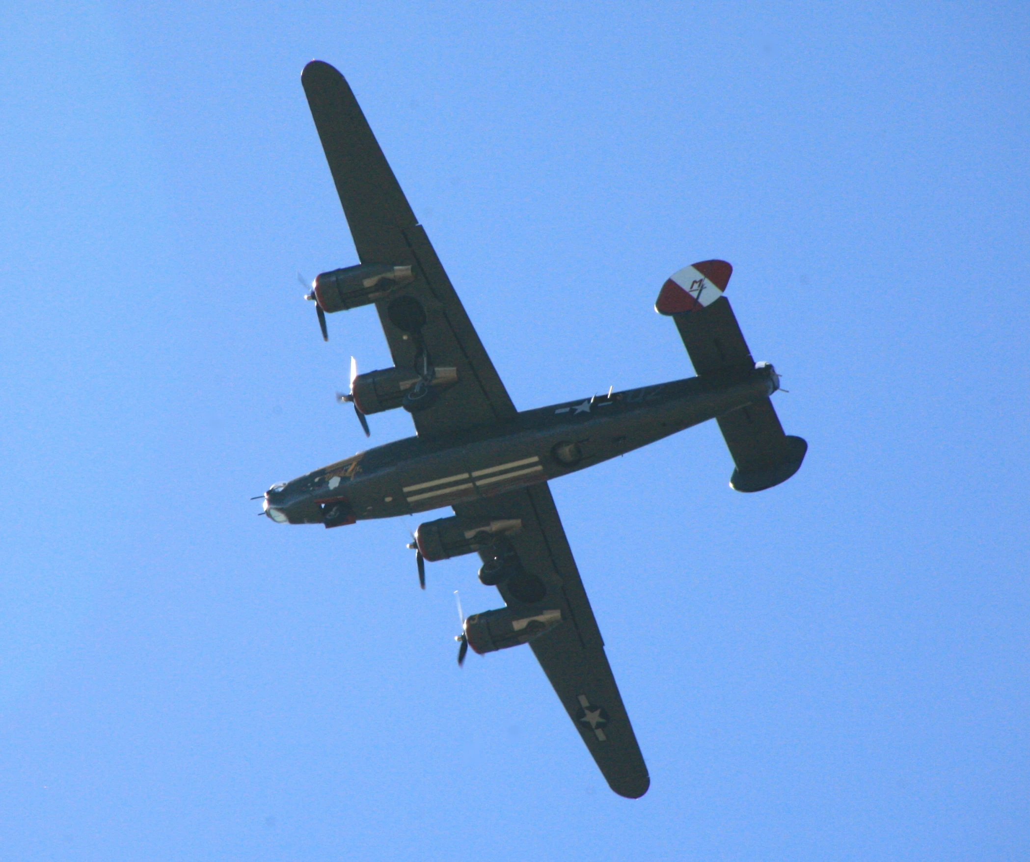 the bottom view of an old model air plane in the sky