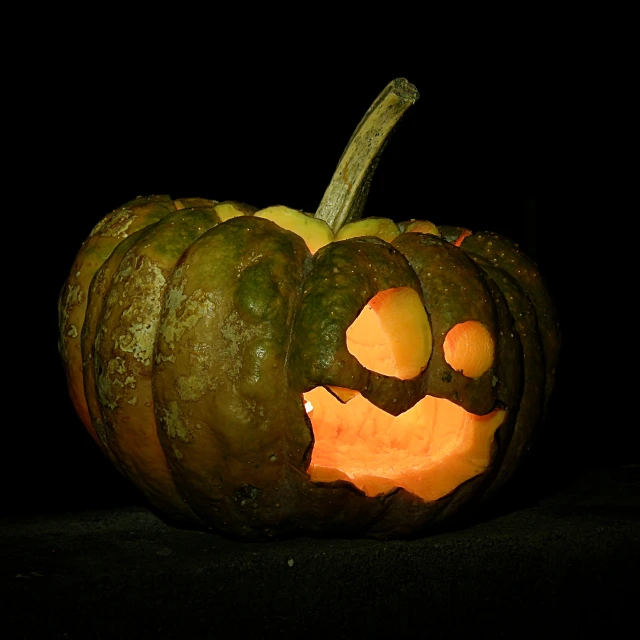 a carved pumpkin is shown as it looks like a face