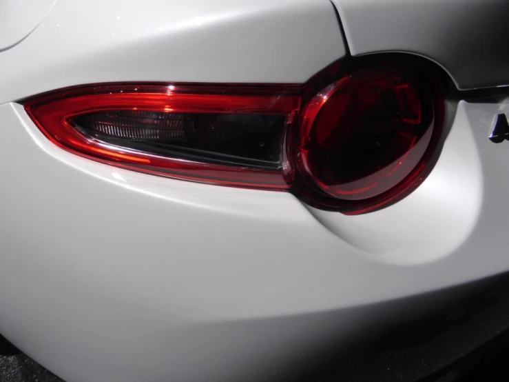 the tail lights of a white car in the night