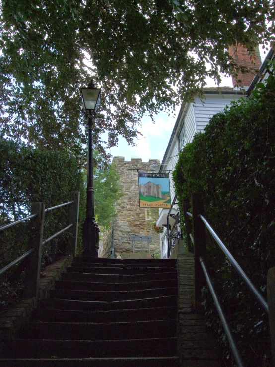 a narrow set of stairs with the sky in the background