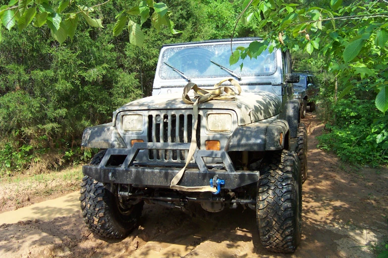 a large army jeep is parked in the dirt
