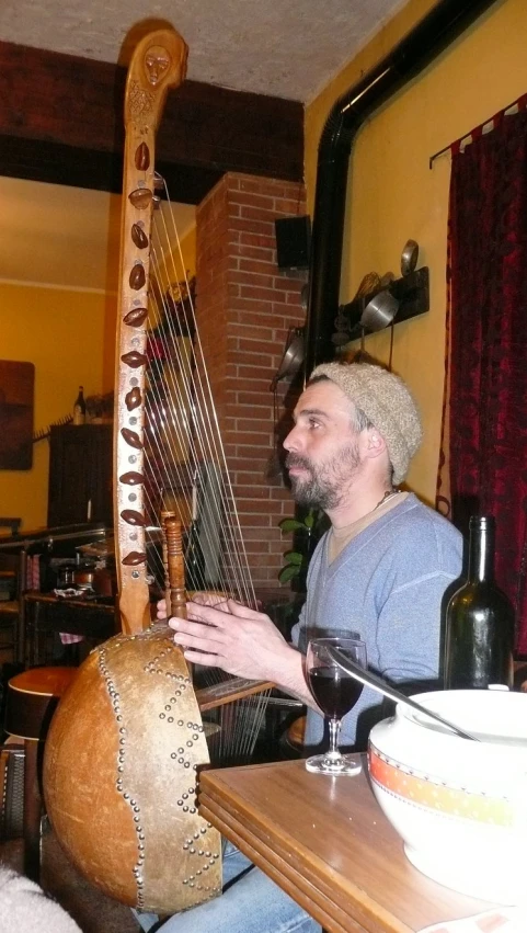 a person sitting in front of a table with a musical instrument