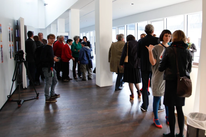 several people are standing in a large building