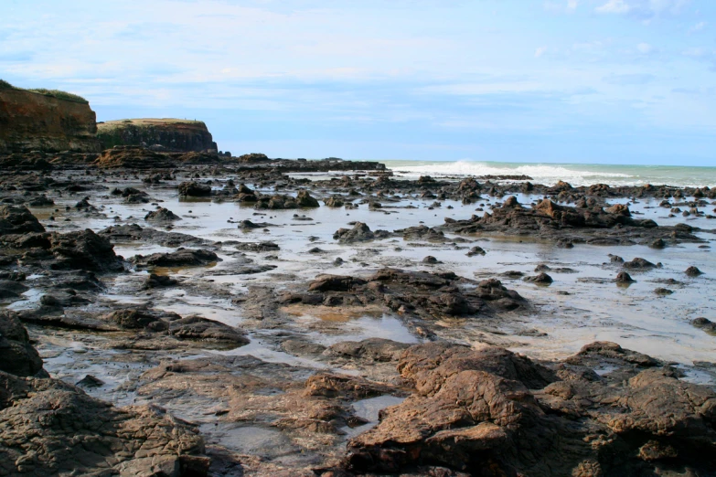 rocks at the ocean shore are seen near the sea