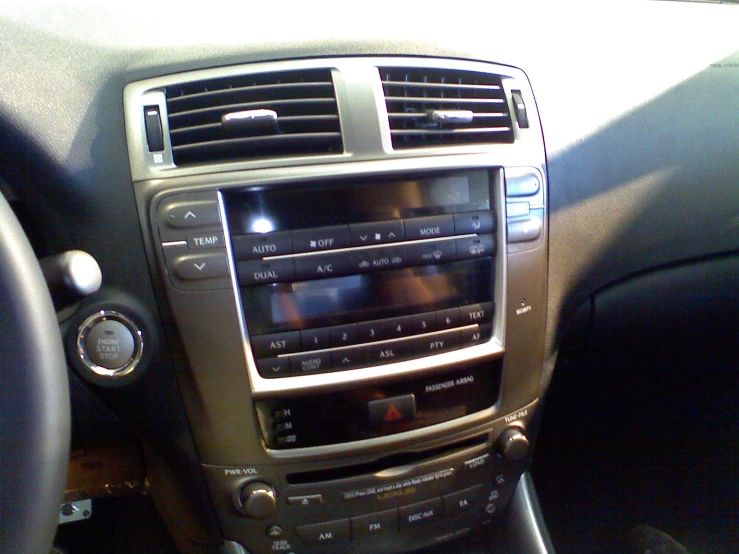 an entertainment system inside of the car on a sunny day