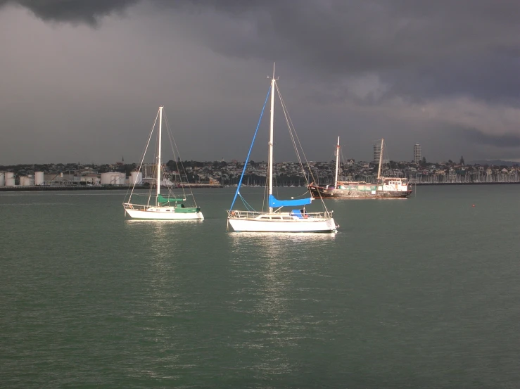 two small boats floating in the middle of the ocean