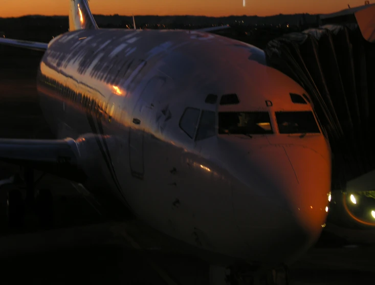 an airplane sits at the airport terminal