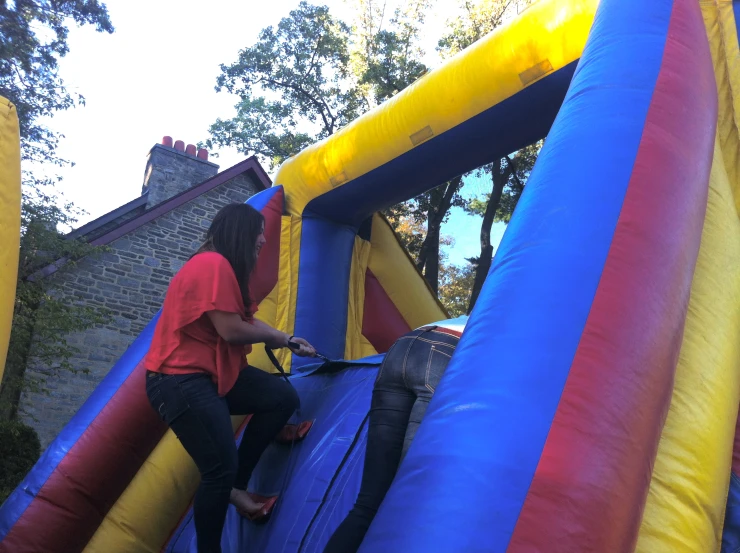 the man is helping a woman get in her bounce house