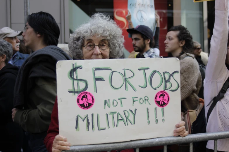 a group of people holding up signs and protest signs