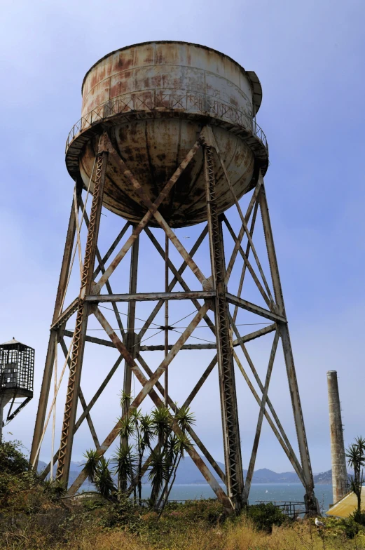 an old tower that is near some water