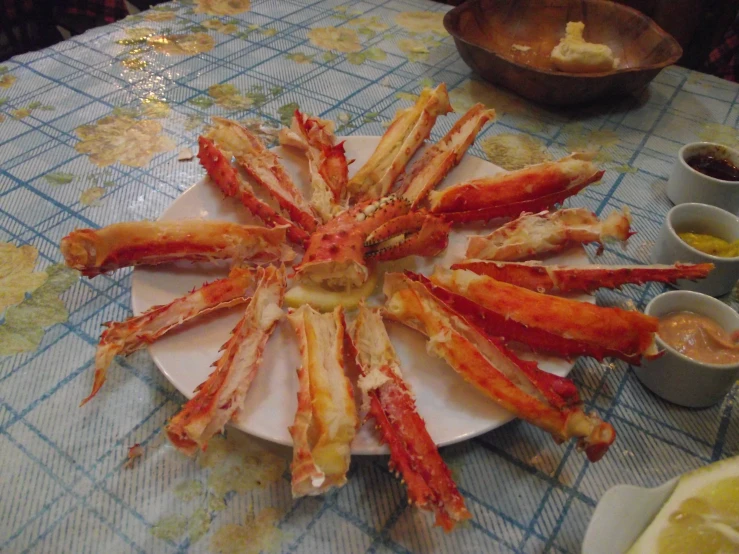 there is a plate full of crab legs sitting on the table