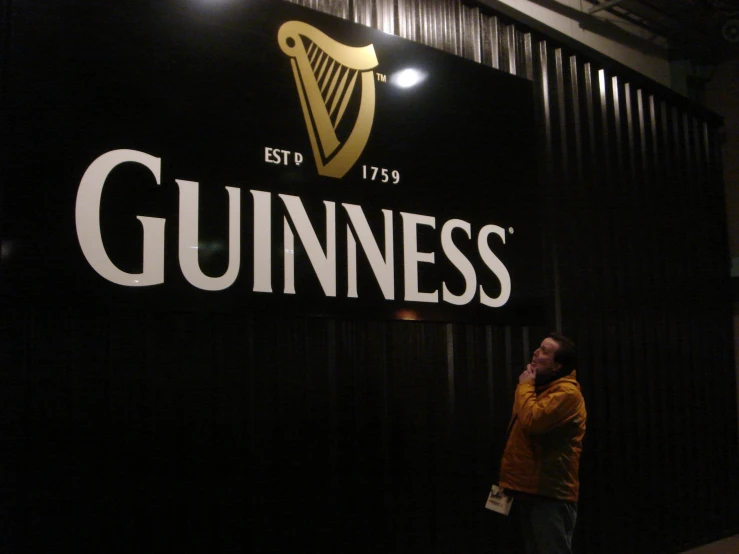 the guinness sign is hanging outside of the guinness pub