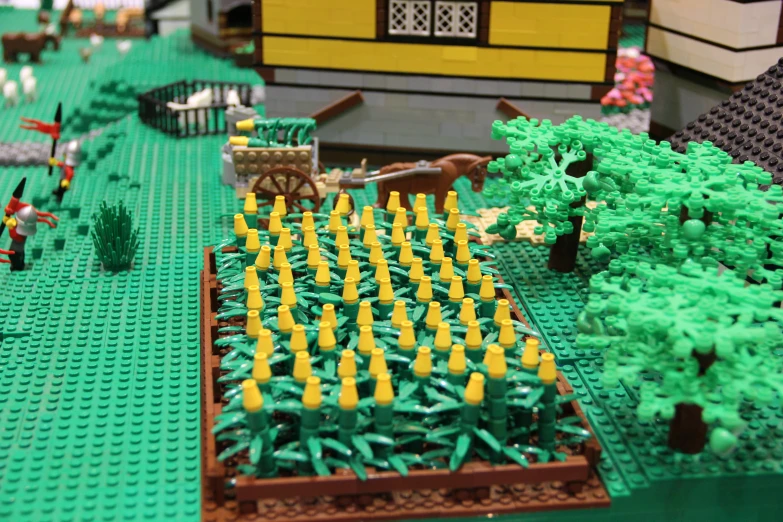 a lego model with a farm scene on display