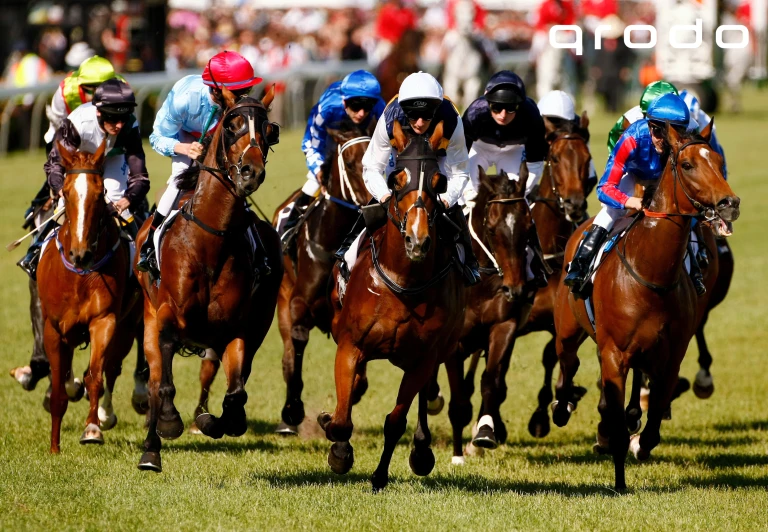 jockeys are riding their horses while the crowd watches