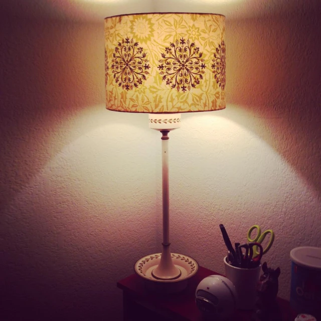 the small lamp is lit in a dim lit room