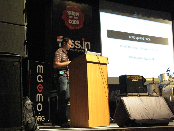 a man standing behind a podium and making a presentation