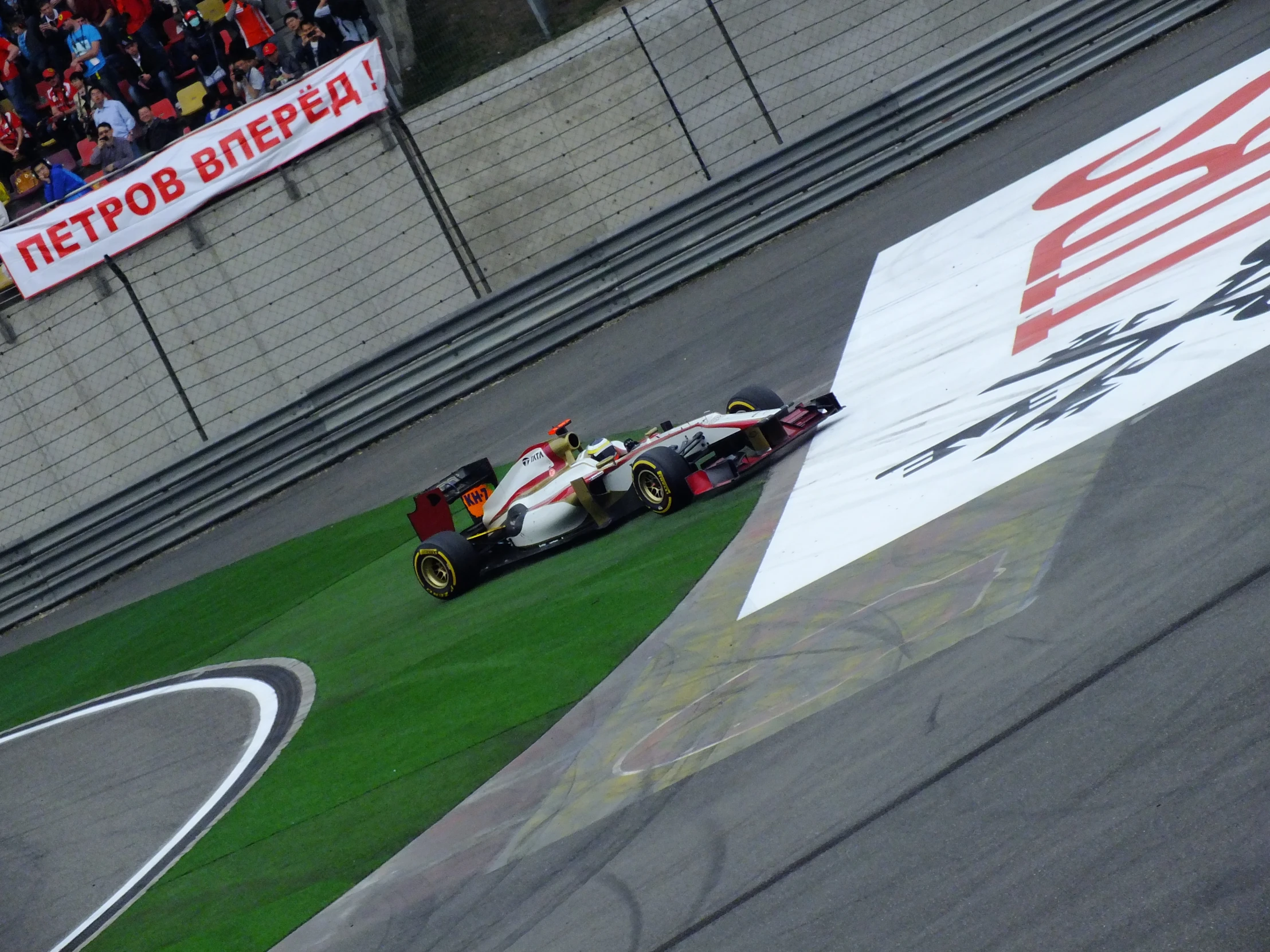 two men are driving a race car down a track