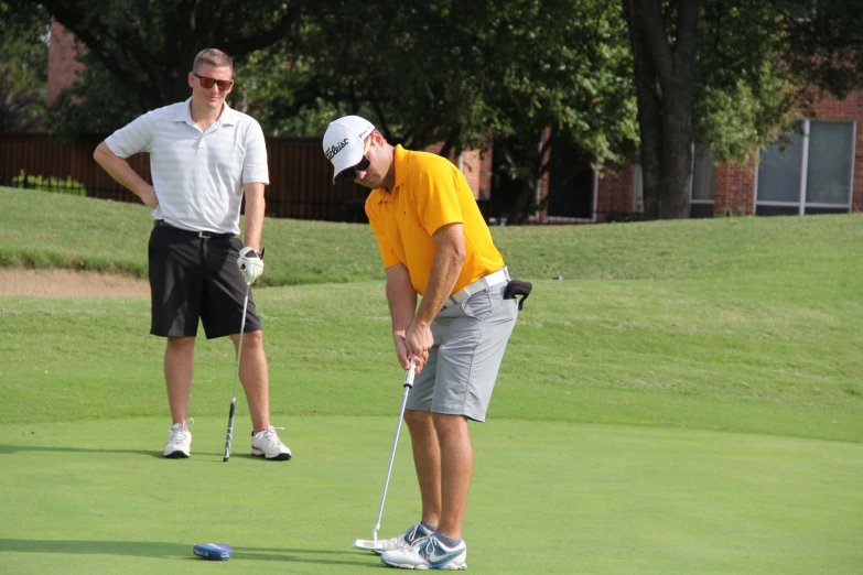 two men in a green golf course