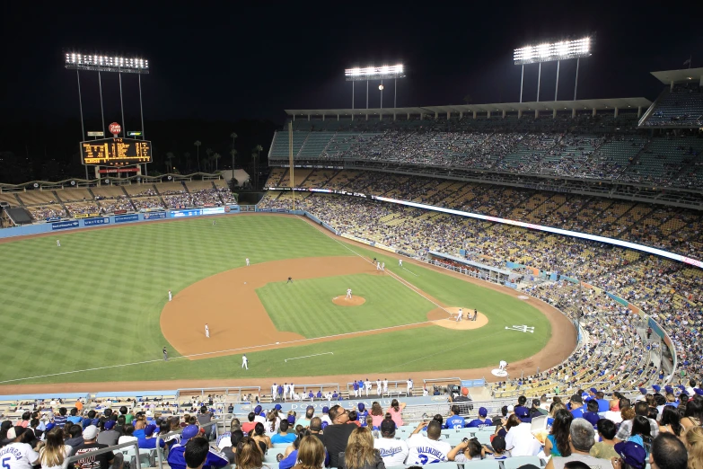 a baseball field at night with the lights on