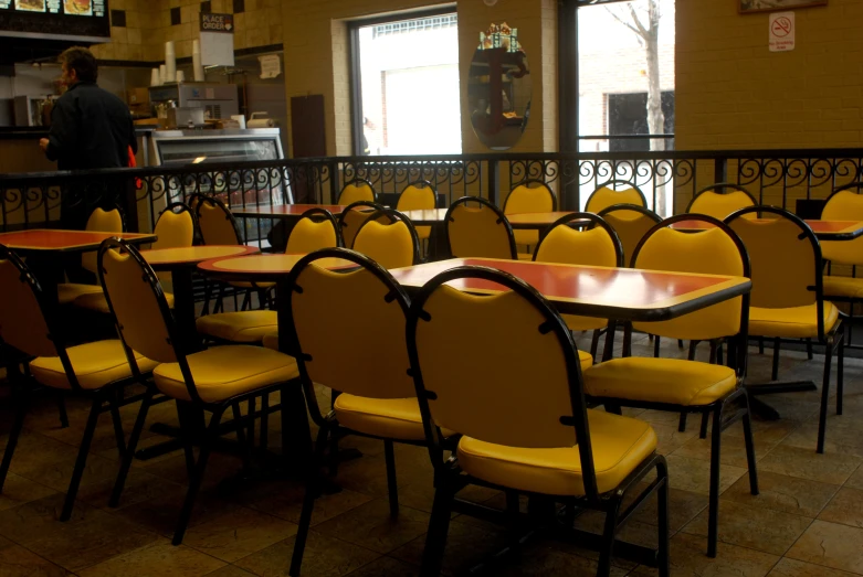 a dining area with yellow chairs, and a bar