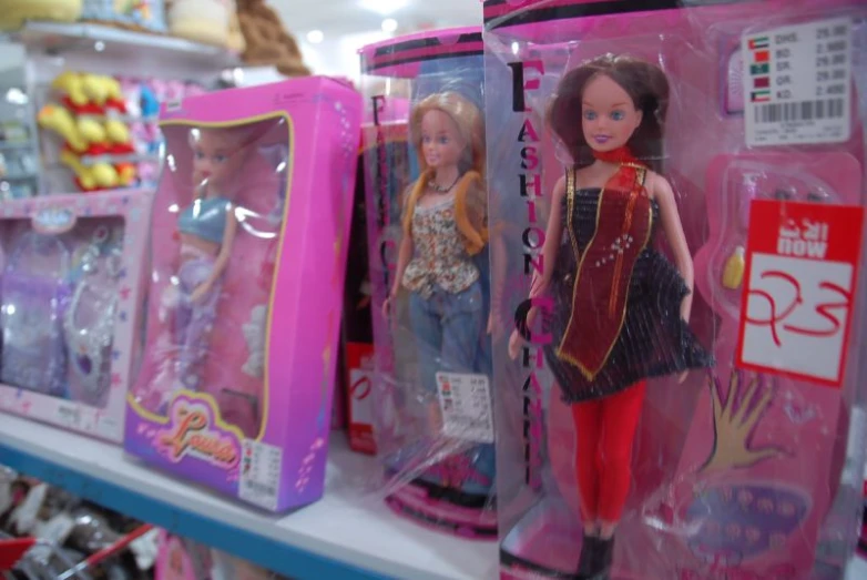 a bunch of barbie dolls that are on the shelves
