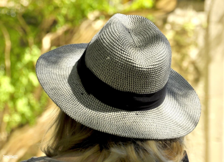 a woman in a gray hat looking off into the distance