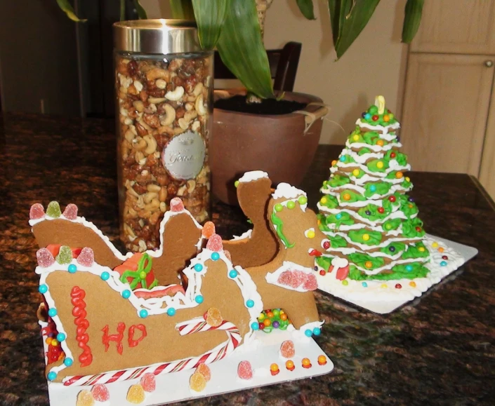 gingerbread decorations on display on table next to vase of plants