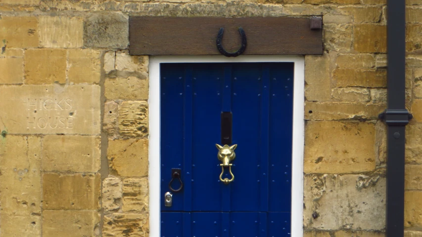 a building has a big blue door with the handle on it