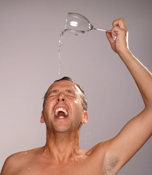 a man is pouring water into his glass