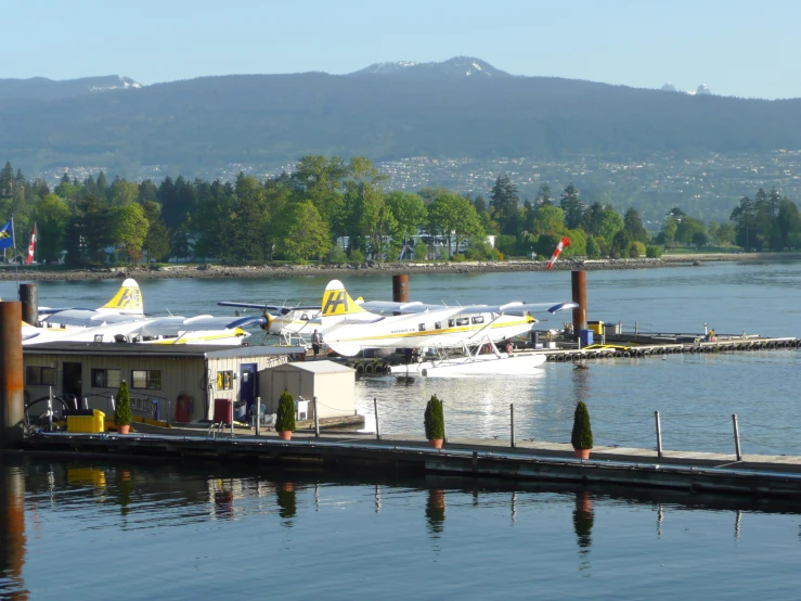 two small plane that are parked at the dock