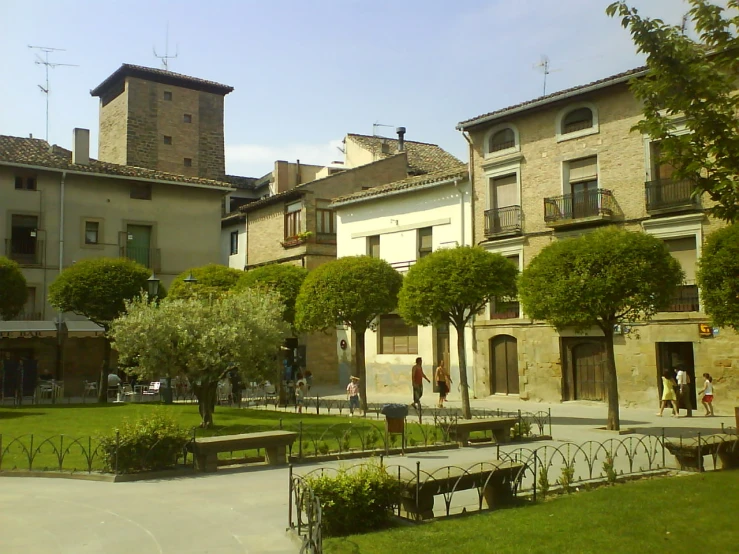a big grassy courtyard next to some buildings