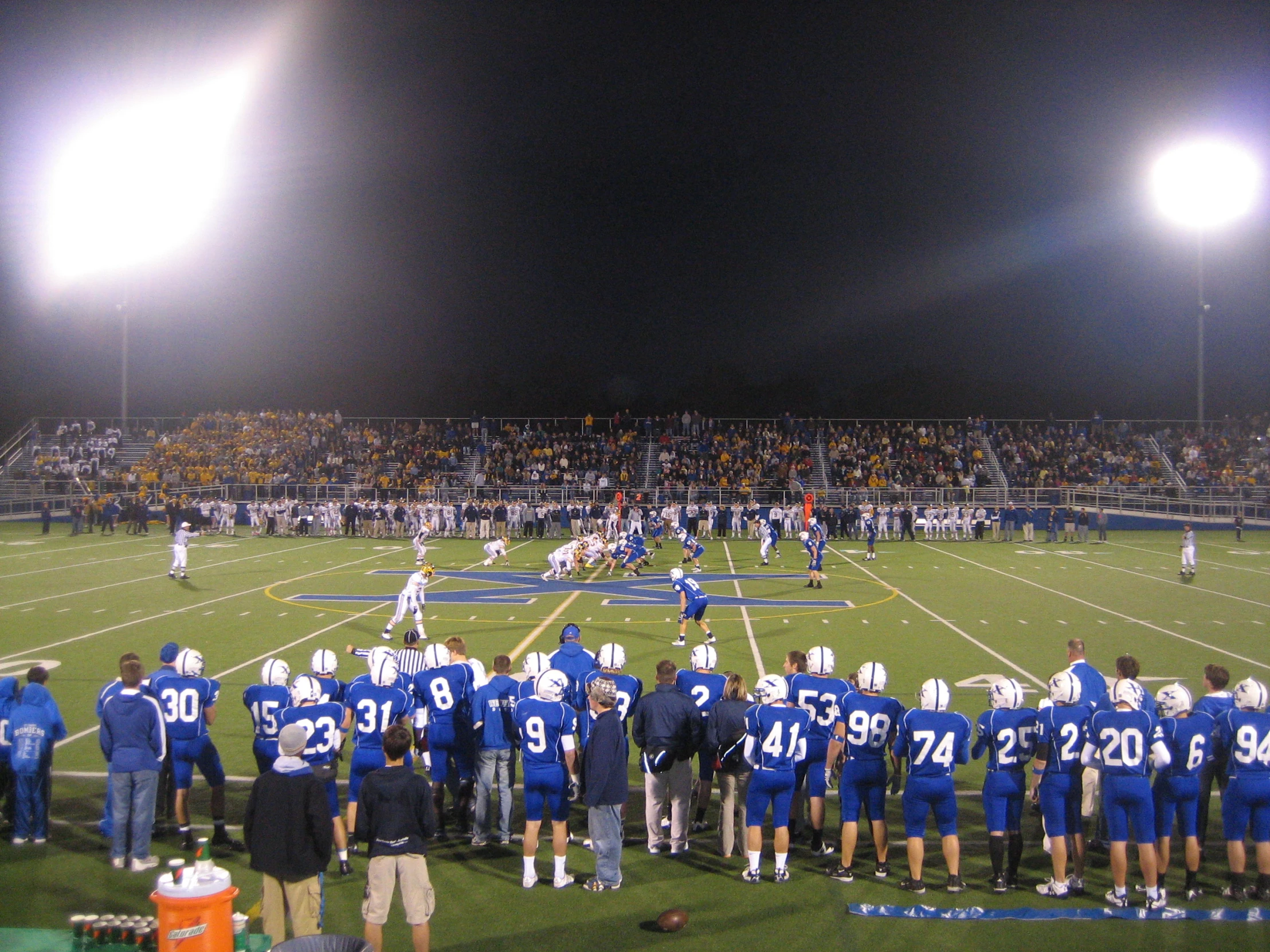 a football game being played on a field in front of an empty stadium