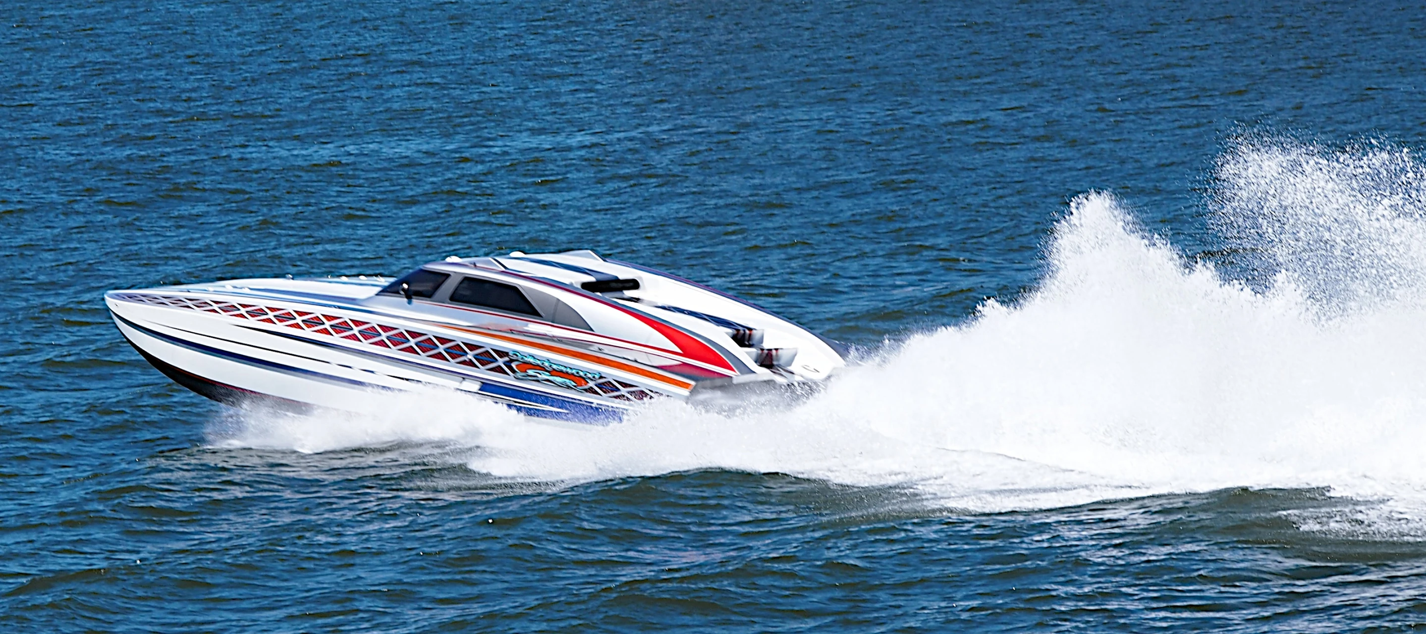 a speedboat splashes water while riding in the ocean