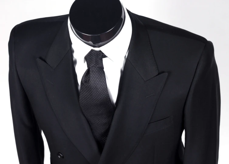 a black suit and tie on a dummy