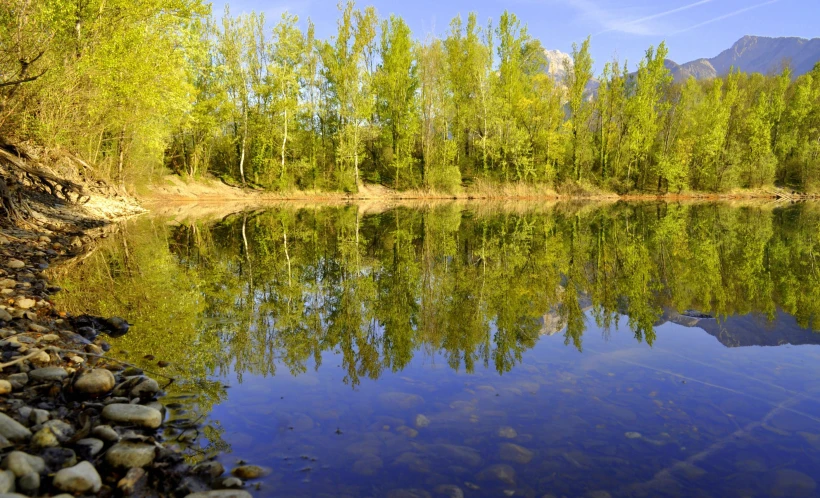 an empty lake is surrounded by rocky shore