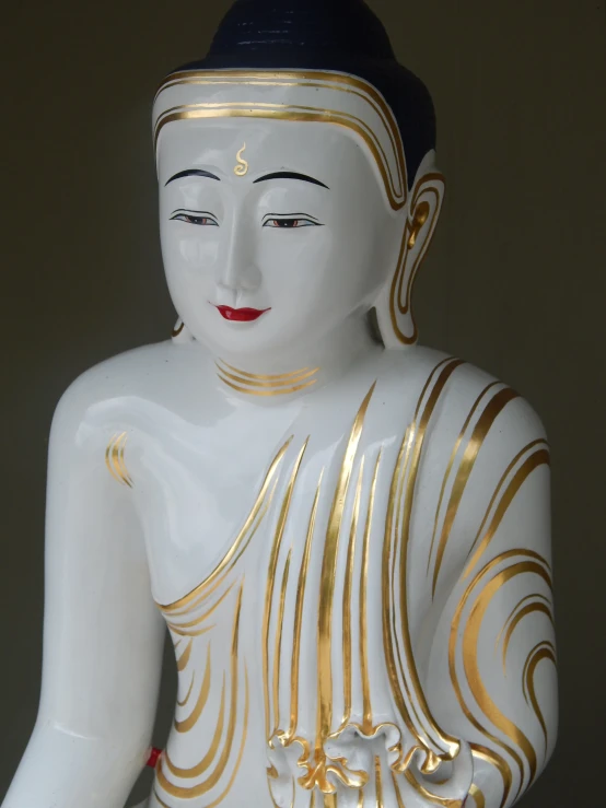 a statue with gold paint and designs on it