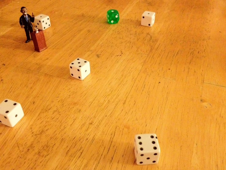 several dices with two toy figures on one side and three on the other